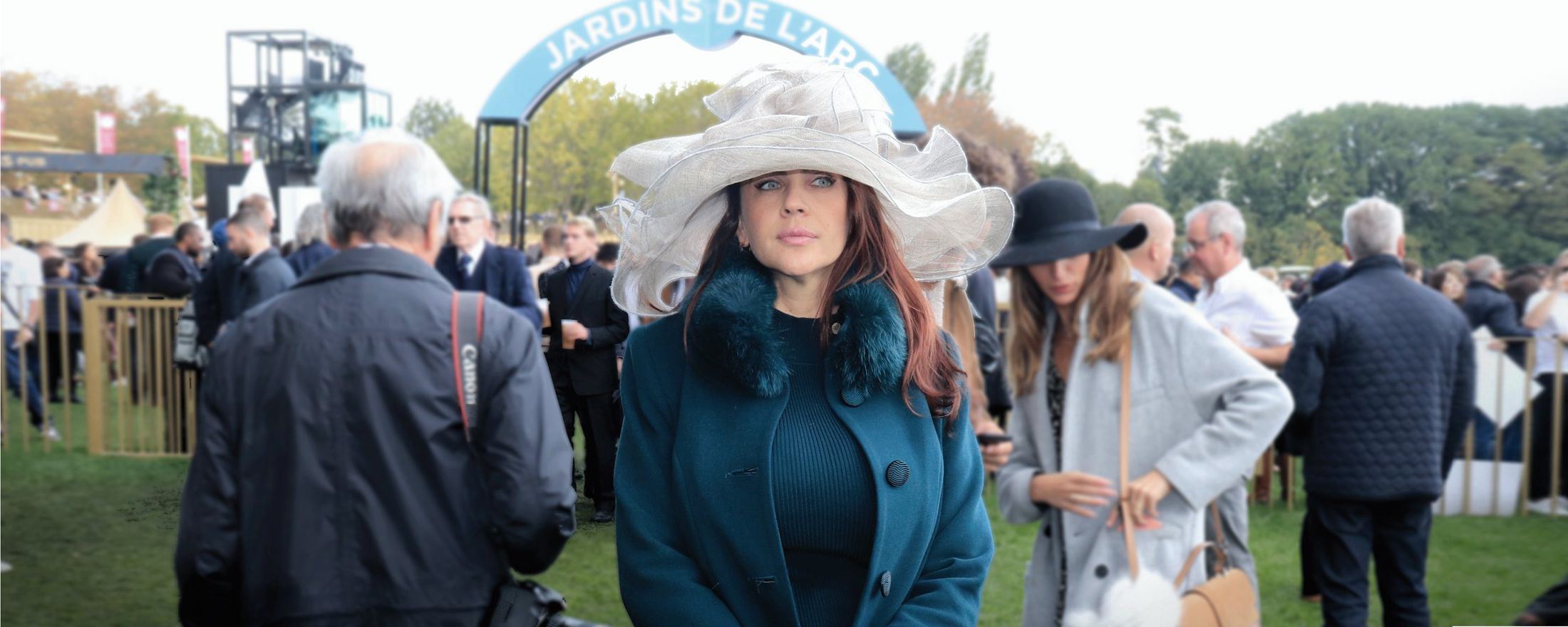 A beautiful woman using a fashionable hat during a luxury travel event in Paris