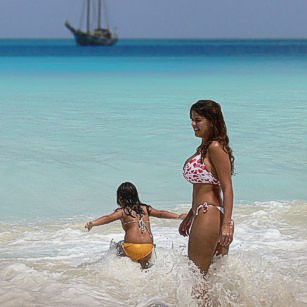 Beautiful Mrs Omnimundi entering the water in a beach in the Seychelles