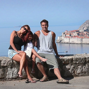 The Omnimundi Family sitting in a road by the sea in Dubrovnik